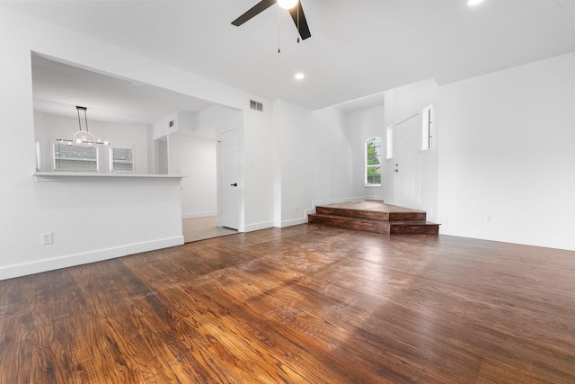 7919 Maiden Ln, Frisco, TX 75035 - unfurnished living room with ceiling fan, wood finished floors, a chandelier, and baseboards