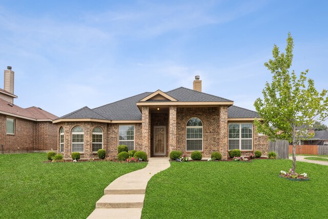 1403 Illinois Ave, Lancaster, TX 75134 - view of front facade featuring brick siding, a chimney, and a shingled roof