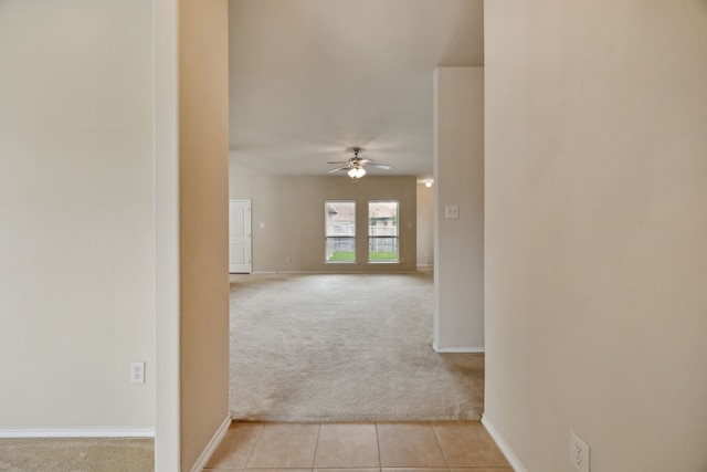 1403 Illinois Ave, Lancaster, TX 75134 - corridor featuring light colored carpet, baseboards, and light tile patterned flooring