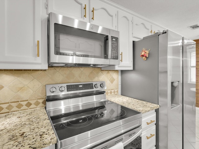 616 Stoneybrook Dr, Wylie, TX 75098 - kitchen with stainless steel appliances, white cabinetry, tasteful backsplash, light stone counters, and tile patterned flooring
