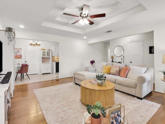616 Stoneybrook Dr, Wylie, TX 75098 - living area featuring a raised ceiling, a ceiling fan, light wood finished floors, recessed lighting, and a chandelier