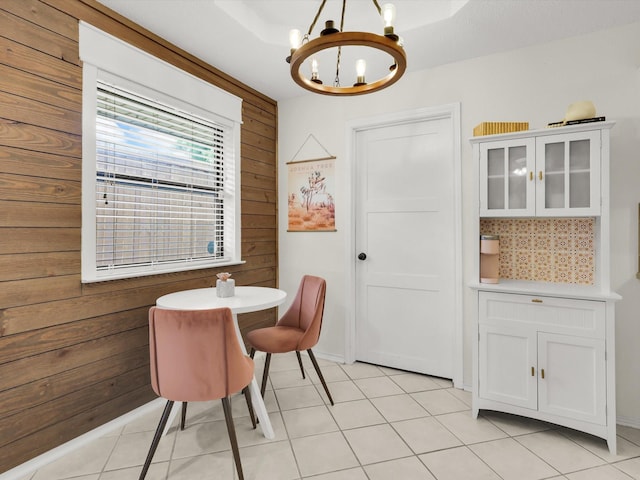 616 Stoneybrook Dr, Wylie, TX 75098 - dining area featuring wooden walls, a chandelier, and light tile patterned floors