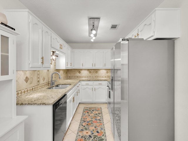 616 Stoneybrook Dr, Wylie, TX 75098 - kitchen with freestanding refrigerator, black dishwasher, a sink, tasteful backsplash, and light tile patterned floors