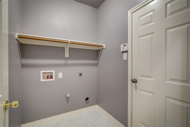 clothes washing area with hookup for an electric dryer, hookup for a washing machine, marble finish floors, and baseboards