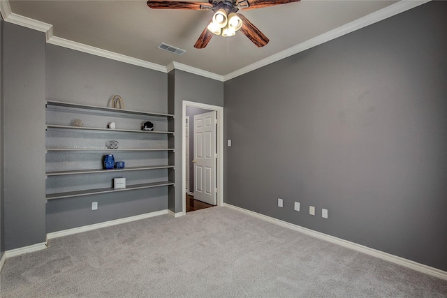 unfurnished bedroom featuring ornamental molding, carpet flooring, baseboards, and ceiling fan