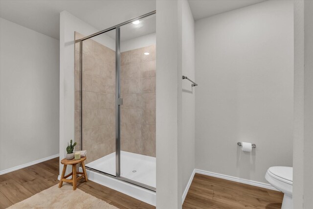 3005 Sherco Rd, Waco, TX 76655 - bathroom with a shower stall, wood finished floors, toilet, and baseboards