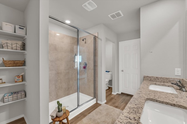 3005 Sherco Rd, Waco, TX 76655 - full bath featuring a stall shower, toilet, wood finished floors, double vanity, and baseboards
