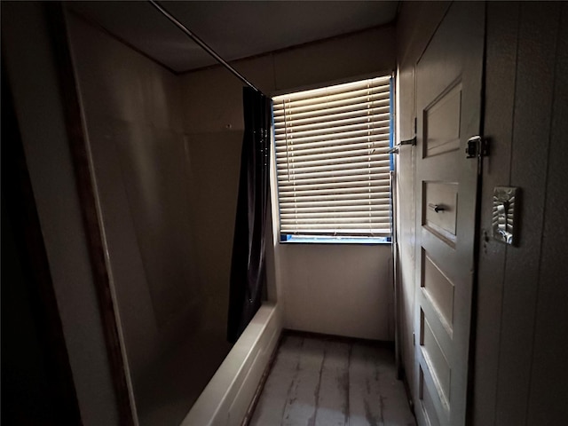 4320 Comanche Dr, May, TX 76857 - bathroom featuring shower / bath combo and wood finished floors