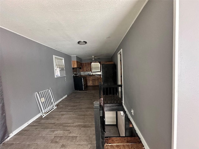 4320 Comanche Dr, May, TX 76857 - interior space with dark wood-style flooring, a textured ceiling, and baseboards