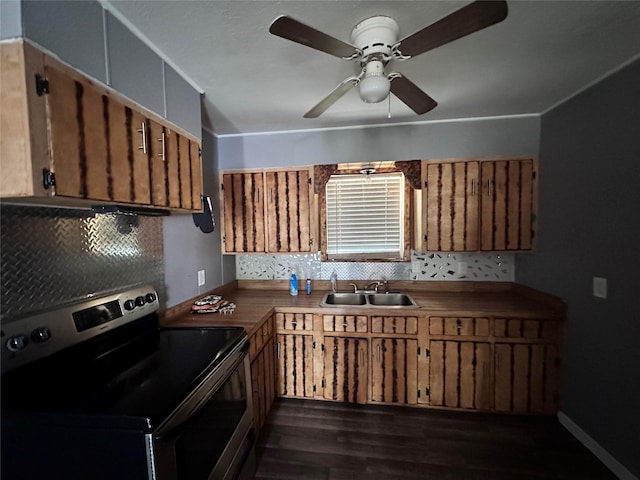 4320 Comanche Dr, May, TX 76857 - kitchen with stainless steel electric stove, a sink, backsplash, and dark wood-style floors