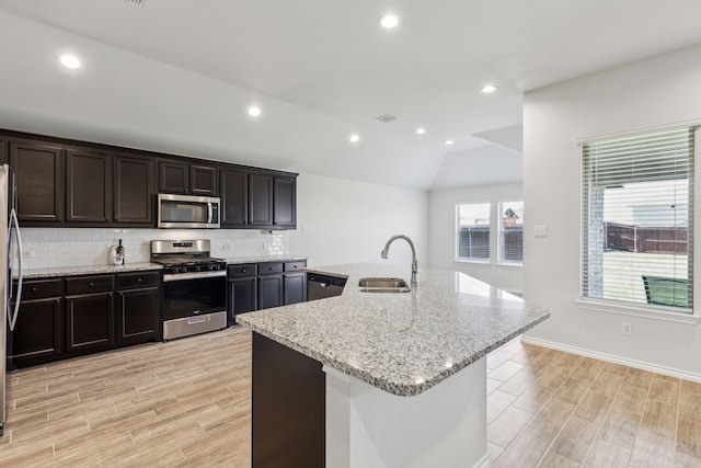 3006 Genevieve Ln, Royse City, TX 75189 - kitchen with stainless steel appliances, a sink, light wood-style floors, decorative backsplash, and recessed lighting