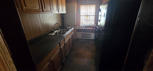 2017 Village Way, Dallas, TX 75216 - kitchen featuring a sink, freestanding refrigerator, and wooden walls