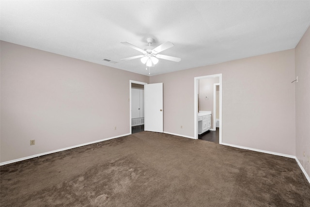 444 Lindenwood Ln W, Hewitt, TX 76643 - unfurnished bedroom with dark colored carpet, baseboards, connected bathroom, and a ceiling fan