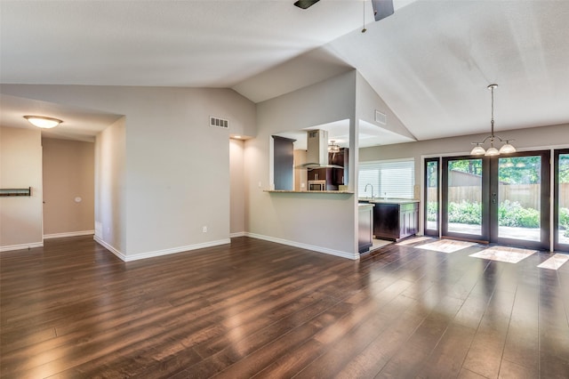 3604 Windsong Ln, Bedford, TX 76021 - unfurnished living room with lofted ceiling, french doors, dark wood-style flooring, baseboards, and a ceiling fan