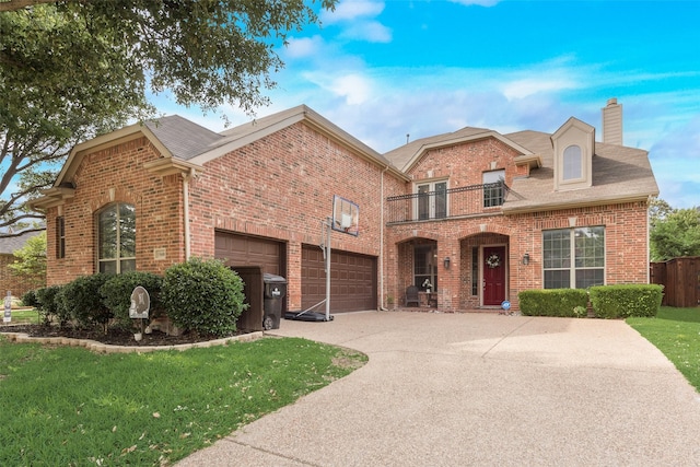 15606 Fox Meadow Ln, Frisco, TX 75035 - traditional-style house with a balcony, brick siding, a chimney, and a front lawn