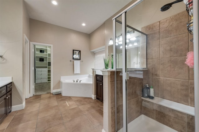 15606 Fox Meadow Ln, Frisco, TX 75035 - bathroom featuring vanity, a shower stall, a garden tub, a spacious closet, and tile patterned flooring