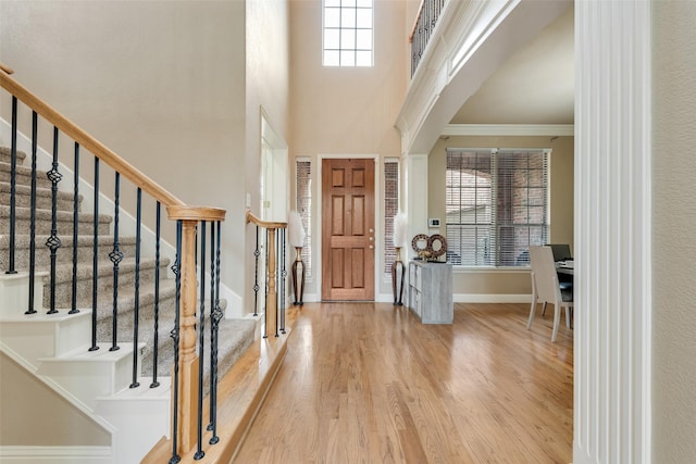 15606 Fox Meadow Ln, Frisco, TX 75035 - foyer with wood finished floors, baseboards, stairway, crown molding, and a towering ceiling