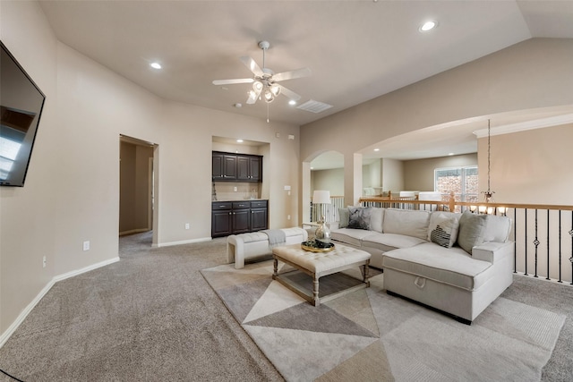 15606 Fox Meadow Ln, Frisco, TX 75035 - living area with arched walkways, ceiling fan, light colored carpet, recessed lighting, and baseboards