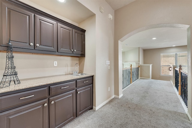 15606 Fox Meadow Ln, Frisco, TX 75035 - indoor wet bar with light colored carpet, arched walkways, baseboards, and recessed lighting