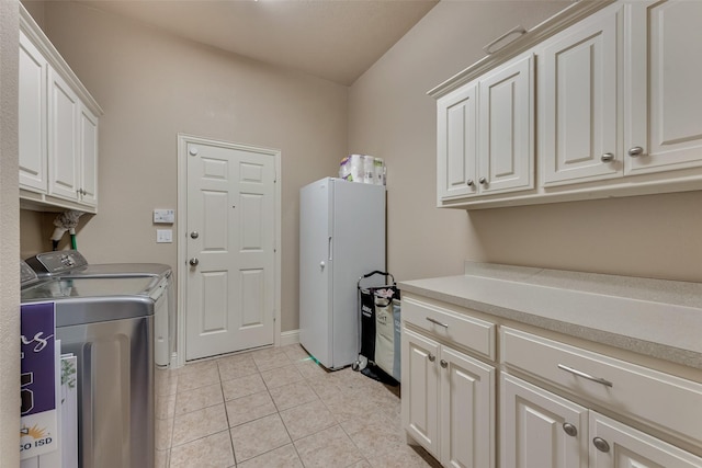 15606 Fox Meadow Ln, Frisco, TX 75035 - laundry area with cabinet space, washer and clothes dryer, and light tile patterned floors