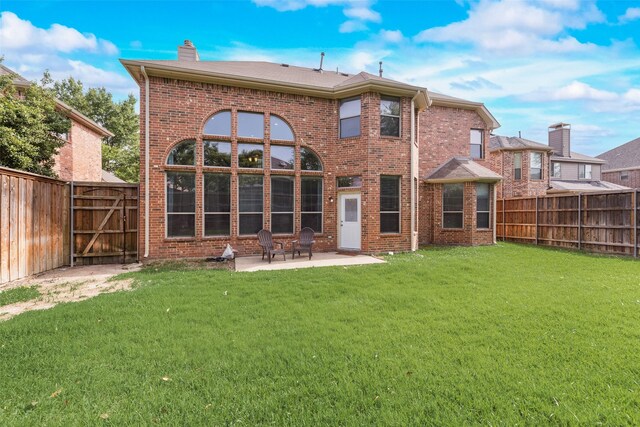 15606 Fox Meadow Ln, Frisco, TX 75035 - rear view of property with a patio area, a chimney, brick siding, and a gate