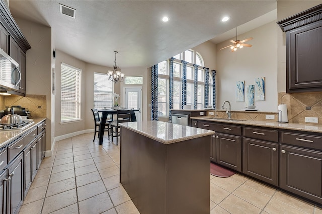 15606 Fox Meadow Ln, Frisco, TX 75035 - kitchen with a sink, plenty of natural light, a kitchen island, a chandelier, and recessed lighting