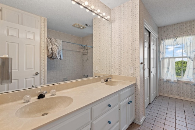 122 Clearview Ln, Fort Worth, TX 76126 - full bath featuring wallpapered walls, tile patterned floors, tiled shower, a textured ceiling, and double vanity