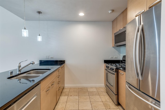 1200 Main St Unit 707, Dallas, TX 75202 - kitchen with appliances with stainless steel finishes, a sink, dark countertops, baseboards, and hanging light fixtures