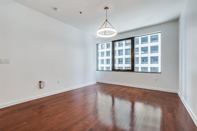 1200 Main St Unit 707, Dallas, TX 75202 - empty room with dark wood finished floors, baseboards, and fire sprinkler in ceiling
