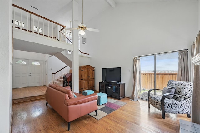 2708 Van Gogh Pl, Dallas, TX 75287 - living room with high vaulted ceiling, light wood-style floors, stairway, a ceiling fan, and beam ceiling