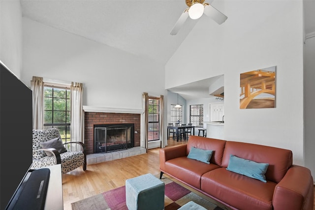 2708 Van Gogh Pl, Dallas, TX 75287 - living area featuring high vaulted ceiling, a fireplace, wood finished floors, and a ceiling fan