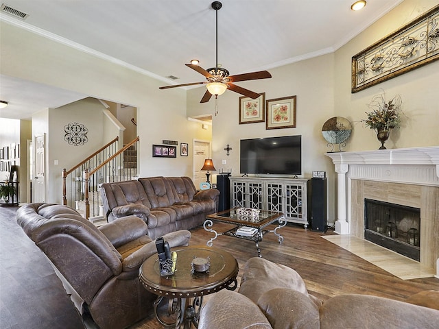 7425 Quiet Meadow Ln, Frisco, TX 75033 - living area featuring a fireplace, wood finished floors, a ceiling fan, stairway, and crown molding