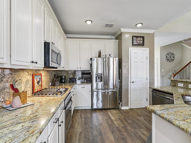 7425 Quiet Meadow Ln, Frisco, TX 75033 - kitchen featuring stainless steel appliances, dark wood finished floors, white cabinetry, ornamental molding, and backsplash
