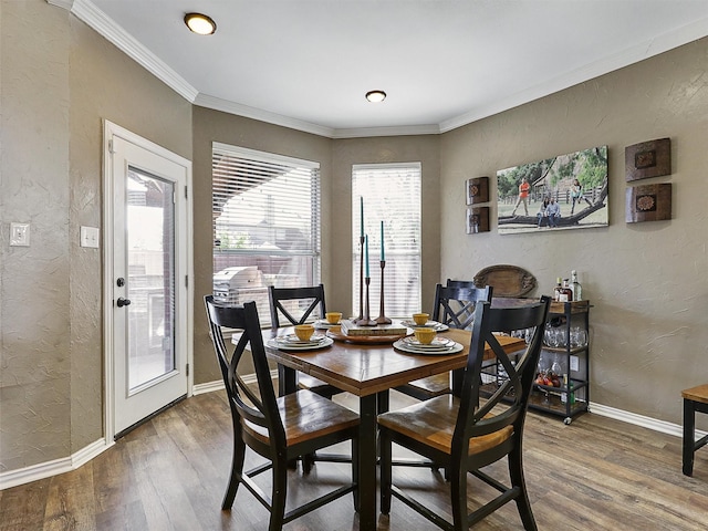 7425 Quiet Meadow Ln, Frisco, TX 75033 - dining area with a textured wall, wood finished floors, baseboards, and crown molding