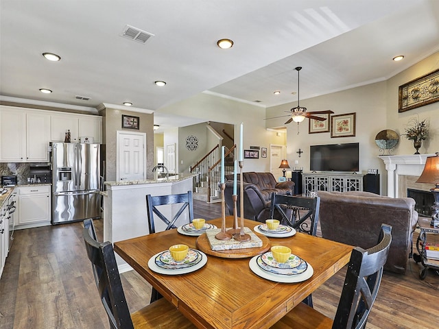 7425 Quiet Meadow Ln, Frisco, TX 75033 - dining area with ornamental molding, a ceiling fan, dark wood-style flooring, stairway, and recessed lighting