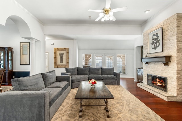 1708 Greenway Dr, Plano, TX 75075 - living area with ceiling fan, a stone fireplace, ornamental molding, dark wood-style flooring, and ornate columns