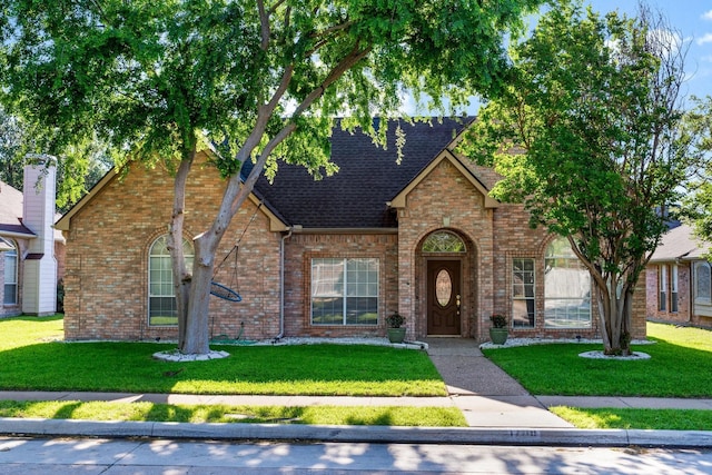 1708 Greenway Dr, Plano, TX 75075 - traditional home with a shingled roof, a front yard, and brick siding