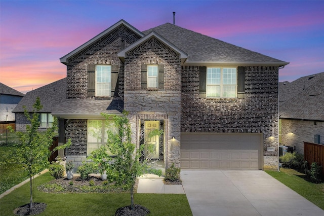 1017 Lade Ct, Celina, TX 75009 - view of front of home with brick siding, a shingled roof, concrete driveway, and an attached garage