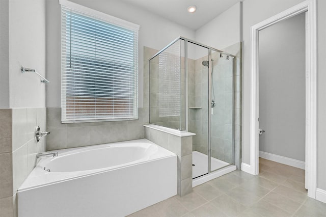 1017 Lade Ct, Celina, TX 75009 - bathroom featuring a shower stall, a garden tub, tile patterned floors, and baseboards