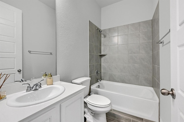 1017 Lade Ct, Celina, TX 75009 - full bath with toilet, washtub / shower combination, vanity, wood finished floors, and a textured wall