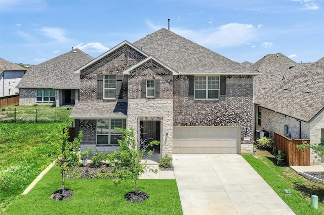 1017 Lade Ct, Celina, TX 75009 - view of front of property featuring brick siding, an attached garage, and roof with shingles