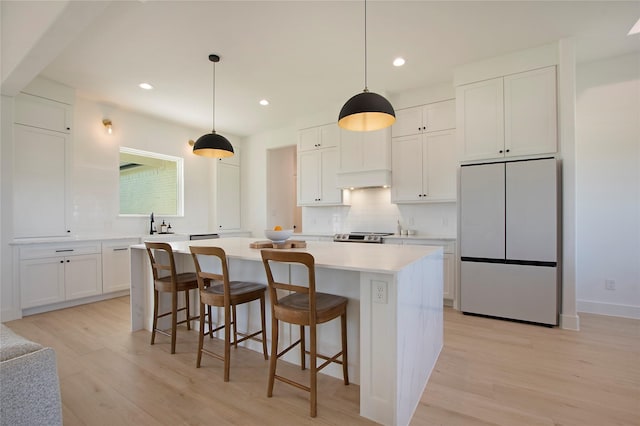 1339 Malone Dr, Royse City, TX 75189 - kitchen with fridge, decorative backsplash, light wood-style flooring, and recessed lighting
