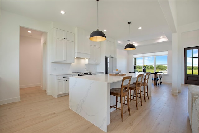1339 Malone Dr, Royse City, TX 75189 - kitchen with freestanding refrigerator, light wood-style flooring, baseboards, recessed lighting, and a spacious island