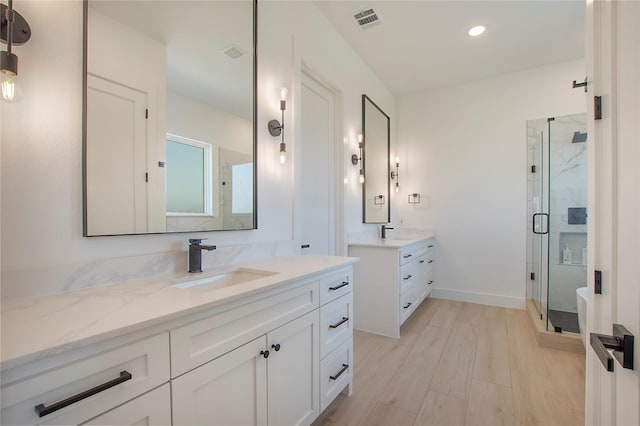 1339 Malone Dr, Royse City, TX 75189 - full bath with a shower stall, two vanities, baseboards, recessed lighting, and wood finished floors