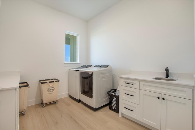 1339 Malone Dr, Royse City, TX 75189 - washroom with independent washer and dryer, cabinet space, light wood-style flooring, and baseboards