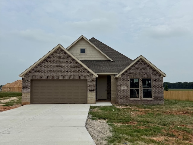 436 Guadalupe Trl, Springtown, TX 76087 - view of front of home with brick siding, roof with shingles, concrete driveway, and a garage