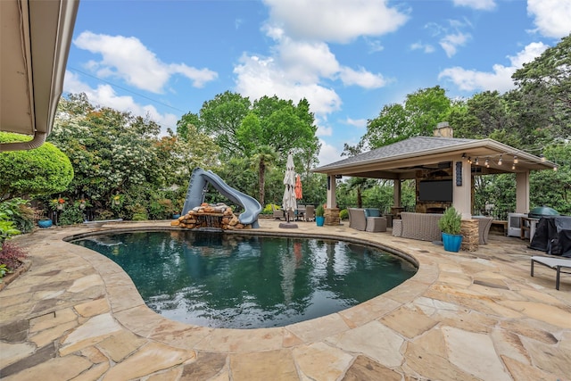 7125 Fish Pond Rd, Waco, TX 76710 - outdoor pool with a gazebo, a water slide, an outdoor living space with a fireplace, a patio, and grilling area