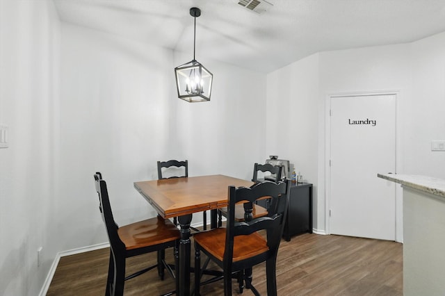 1010 Greenbriar Ln, Mckinney, TX 75069 - dining area featuring wood finished floors, a chandelier, and baseboards