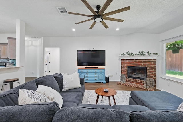1010 Greenbriar Ln, Mckinney, TX 75069 - living area featuring dark wood-type flooring, a ceiling fan, a fireplace, recessed lighting, and baseboards