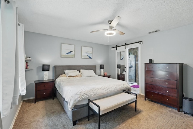 1010 Greenbriar Ln, Mckinney, TX 75069 - bedroom with a barn door, light carpet, a textured ceiling, a ceiling fan, and baseboards